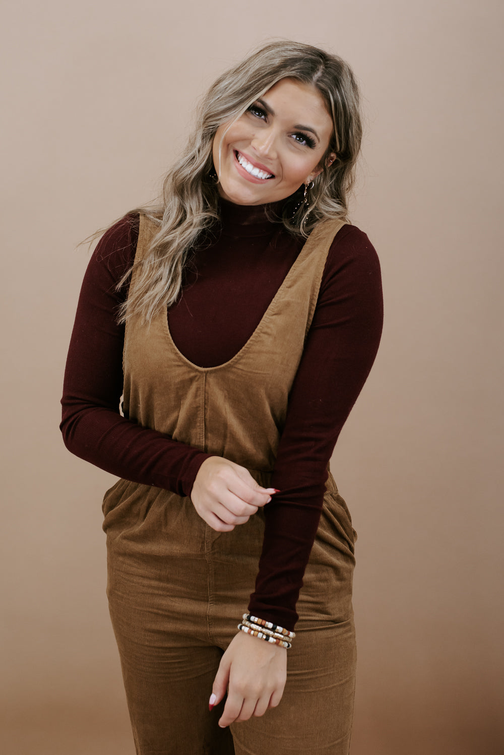 Brown overalls with mockneck sweater