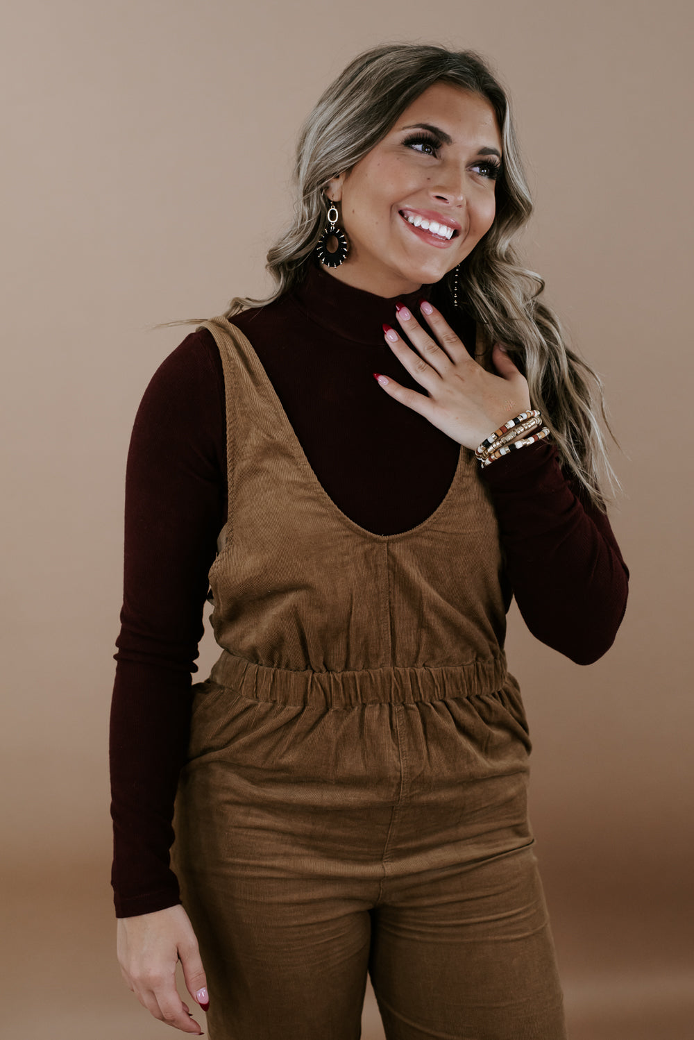 Brown overalls with mockneck sweater